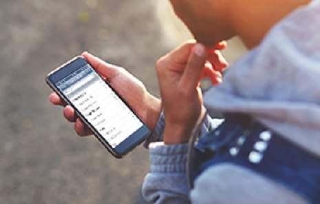 Retrieving Deleted Text Messages. A person using a smartphone to review message backups and recovery options, representing lawful, user-authorised message retrieval.